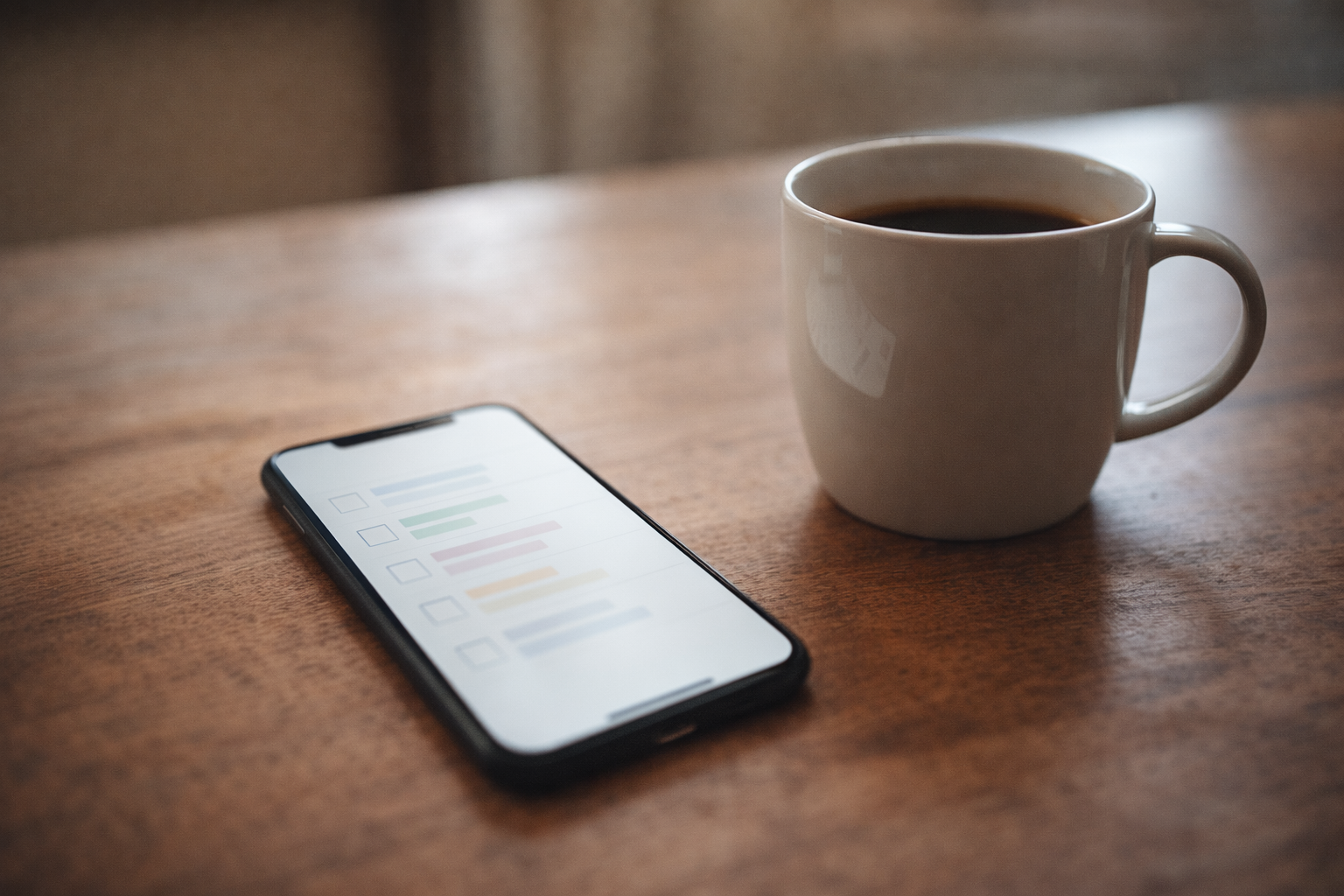 A calm morning scene with a phone on a table next to a coffee cup - this is just part of my morning now